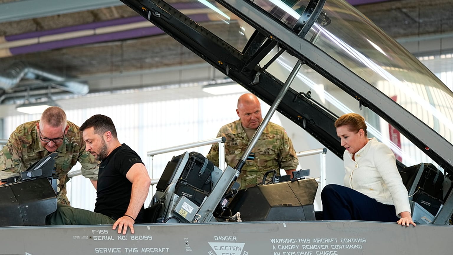 Ukrainian President Volodymyr Zelenskyy and Denmark's Prime Minister Mette Frederiksen sit in a F-16 fighter jet at Skrydstrup Airbase, Denmark, Sunday, Aug. 20, 2023