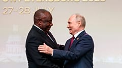 President of the Republic of South Africa Cyril Ramaphosa, left, and Russian President Vladimir Putin shake hands in St Petersburg, Russia, July 27, 2023.
