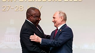 President of the Republic of South Africa Cyril Ramaphosa, left, and Russian President Vladimir Putin shake hands in St Petersburg, Russia, July 27, 2023.
