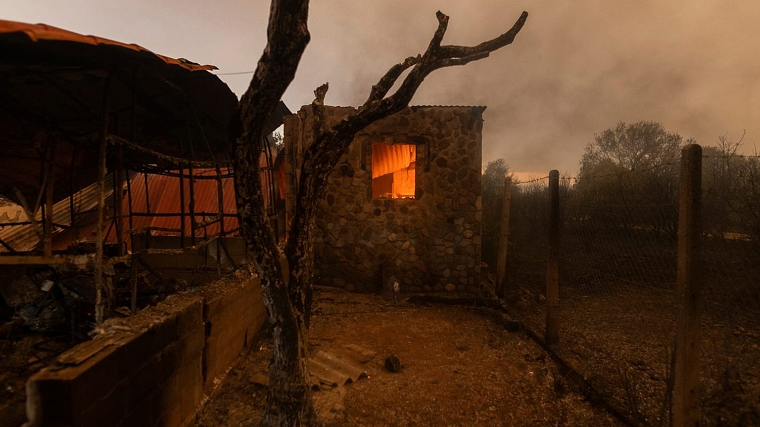 A warehouse on fire in the village of Dikela, near Alexandroupolis town, in the northeastern Evros region, Greece, Tuesday, Aug. 22, 2023.
