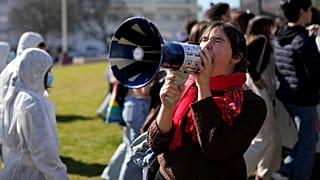 A protestor shouts into a megaphone during a Fridays For Future demonstration in Portugal.