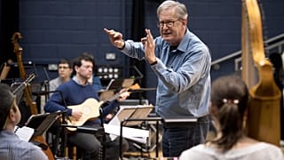 British composer Sir John Eliot Gardiner conducts the orchestra during a rehearsal session at Sadler's Wells Theatre in London.