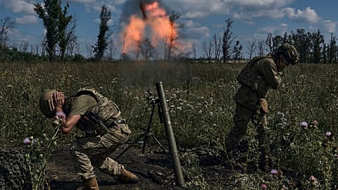 Ukrainian soldiers fire a mortar towards Russian positions at the front line, near Bakhmut, Donetsk region