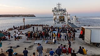 Migrant centreMigrants wait to board an Italian Coast Guard ship in the Sicilian Island of Lampedusa, Italy. in Lampedusa