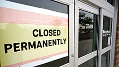 FILE - A permanently closed business displays a sign in January 2021.