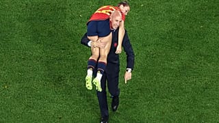 Luis Rubiales carrying spanish female player