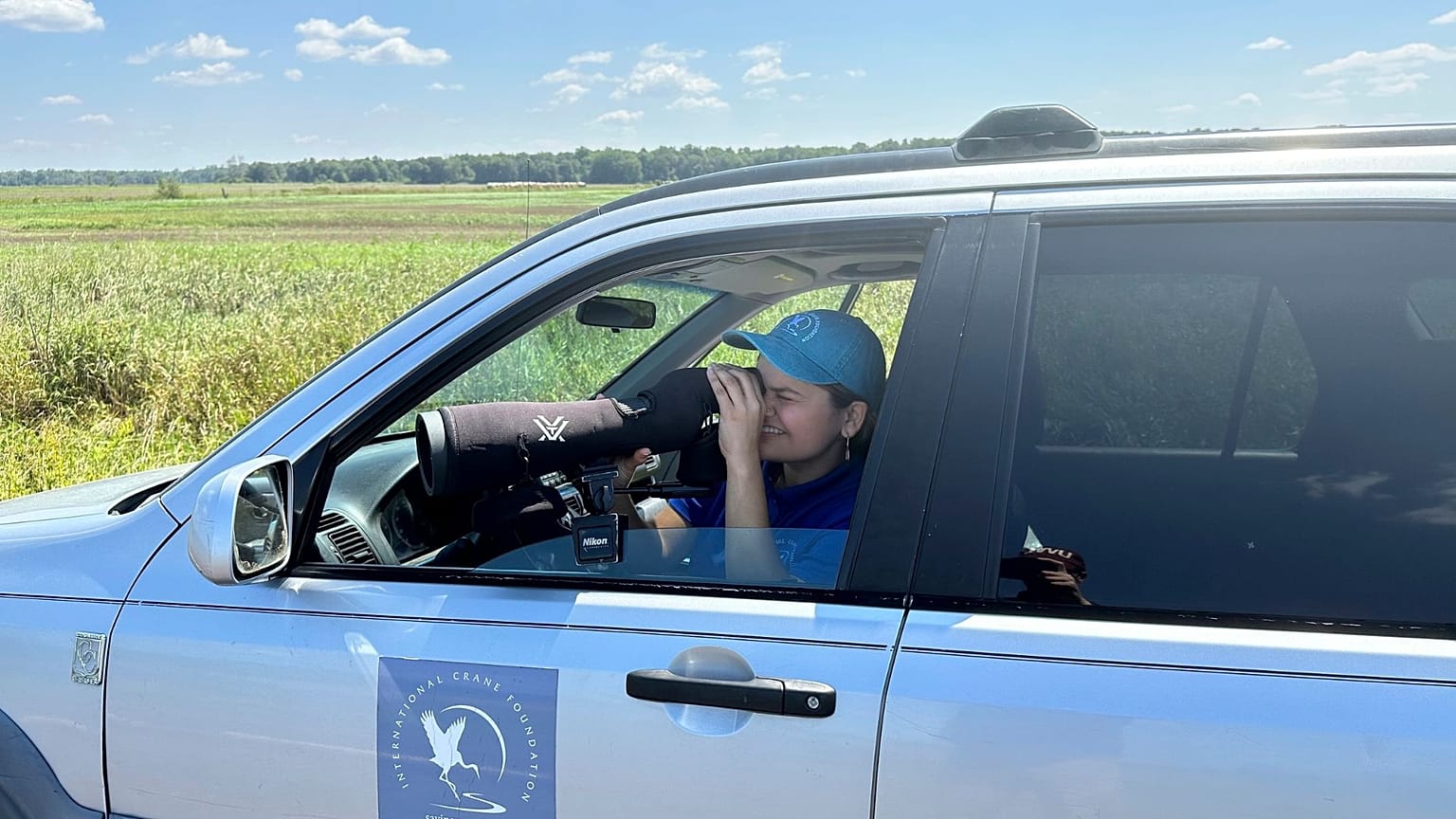 University of Wisconsin-Madison senior Arianna Barajas searches for signs of cranes on Tuesday, Aug. 15, 2023. Barajas identifies as Mexican-American