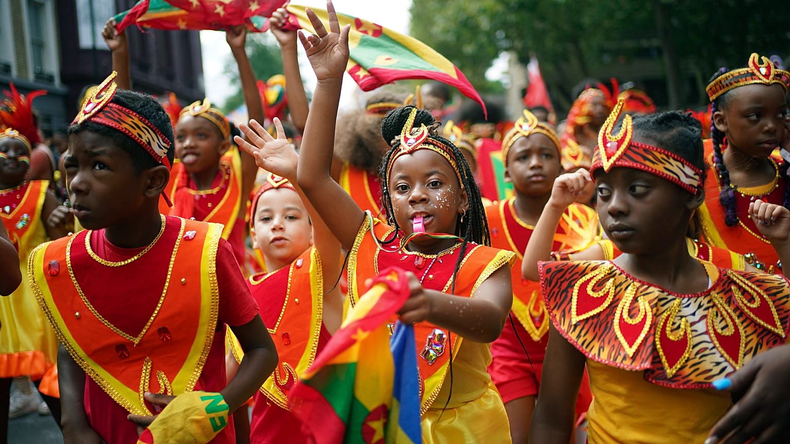 Participants dance during the Children's Day Parade, part of the Notting Hill Carnival celebration in west London