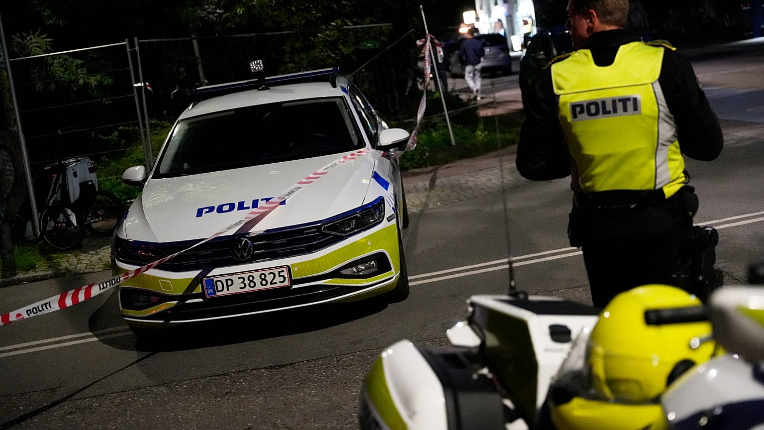 Police stand guard in the Freetown Christiania neighbourhood of Copenhagen, Denmark, Saturday, Aug. 26, 2023. 