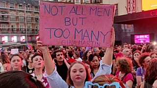 A woman holds a placard as demonstrators gather in the centre of Madrid, Spain