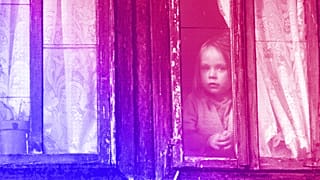 A girl peers from the window of her old family house near the Bosnian town of Kalesija, 2012
