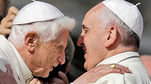 Pope Francis, right, hugs Pope Emeritus Benedict XVI prior to the start of a meeting with elderly faithful in St. Peter's Square at the Vatican, Sept. 28, 2014. 