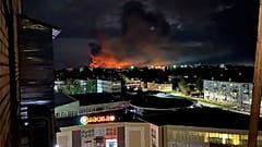 This image made from a social media and and provided by Ostorozhno Novosti shows smoke billowing over the city and a large blaze in Pskov, Russia, on Aug. 29, 2023.