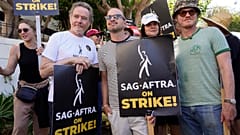 Rhea Seehorn, from left, Bryan Cranston, Aaron Paul, Betsy Brandt and Jesse Plemons, from the cast of "Breaking Bad," strike on a picket line outside Sony Pictures studios