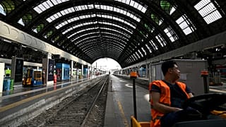 An employee looks on at the Milan Central train station as Italy's rail workers are on strike in Milan, on July 13, 2023.