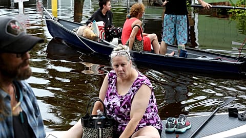 Residents of Twin City Mobile Home Park, navigate through the neighborhood in high waters, Wednesday, Aug. 30, 2023, in St. Petersburg, Florida
