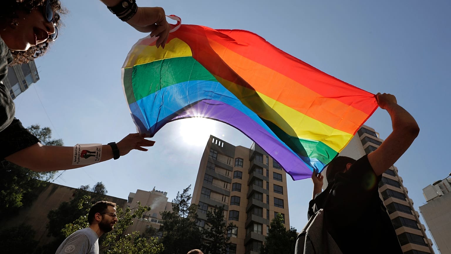 Aktivisten der LGBTQ+-Gemeinschaft im Libanon schreien Slogans und halten einen Regenbogen hoch, um Rechte zu fordern, während einer Demonstration in Beirut, 2020