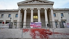 A protest at the Marseille courthouse features red dye representing the blood of victims of feminicide in March