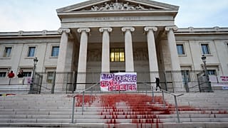 A protest at the Marseille courthouse features red dye representing the blood of victims of feminicide in March