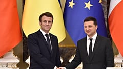 Ukrainian President Volodymyr Zelenskyy and his French counterpart Emmanuel Macron shake hands in Kyiv, 2022