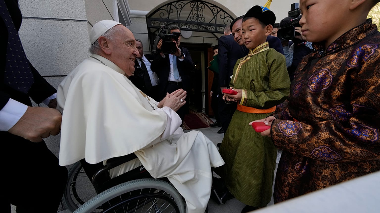 Children in traditional dress welcome Pope Francis arriving for a meeting with charity workers and for the inauguration of the House of Mercy in Ulaanbaatar, Monday, Sept. 4.