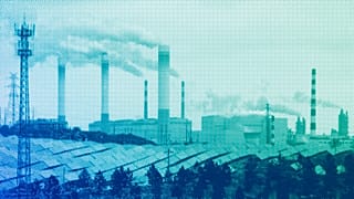 Smoking chimneys and solar panel farm are seen along a highway in a coal producing region in Yulin, April 2023
