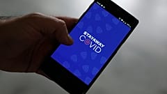 A man shows the contact tracing app Stayaway Covid on his cellphone, in Lisbon.