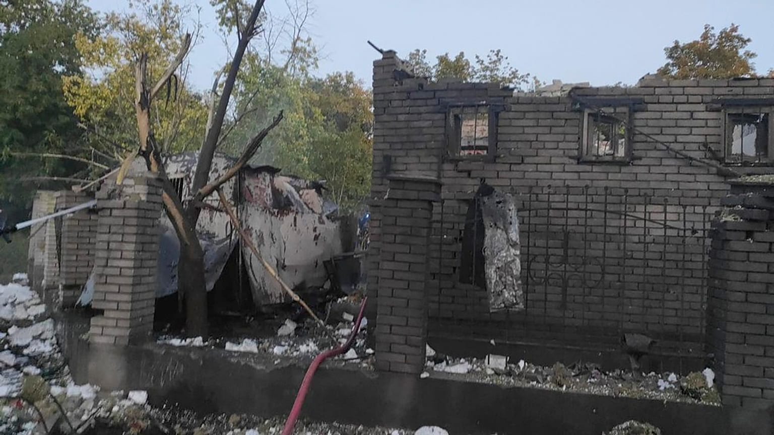 In this photo provided by the Zaporizhzhia administration Press Office, rescuers work on the scene of a building damaged after Russian missile strikes in Zaporizhzhia.