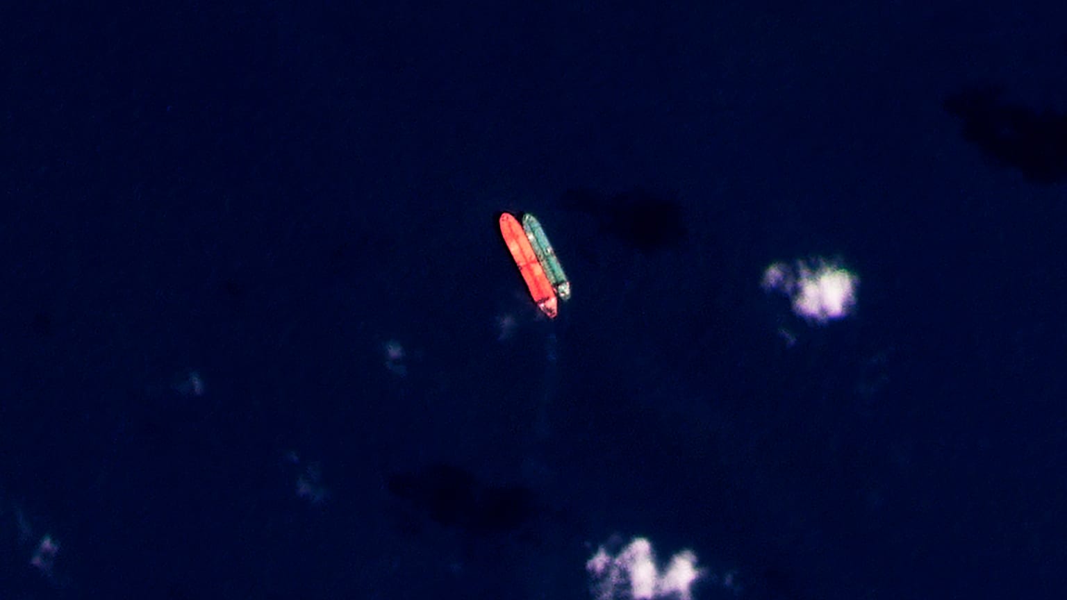 In this satellite photo provided by Planet Labs PBC, vessels identified as the Virgo, left, and the Suez Rajan, by the advocacy group United Against Nuclear Iran, are seen in 