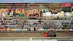 A woman shops at a supermarket in Warsaw, Poland, on Dec. 9, 2022.