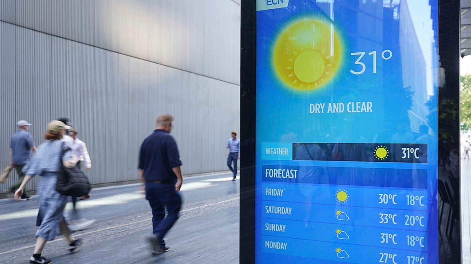 People walking past a weather report in Tower Bridge, London, England, Thursday Sept. 7, 2023 