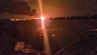 A fireball lights the horizon on the Ukrainian shore of the Danube, seen from Chilia Veche in eastern Romania on the night of Tuesday, Sept. 5, 2023