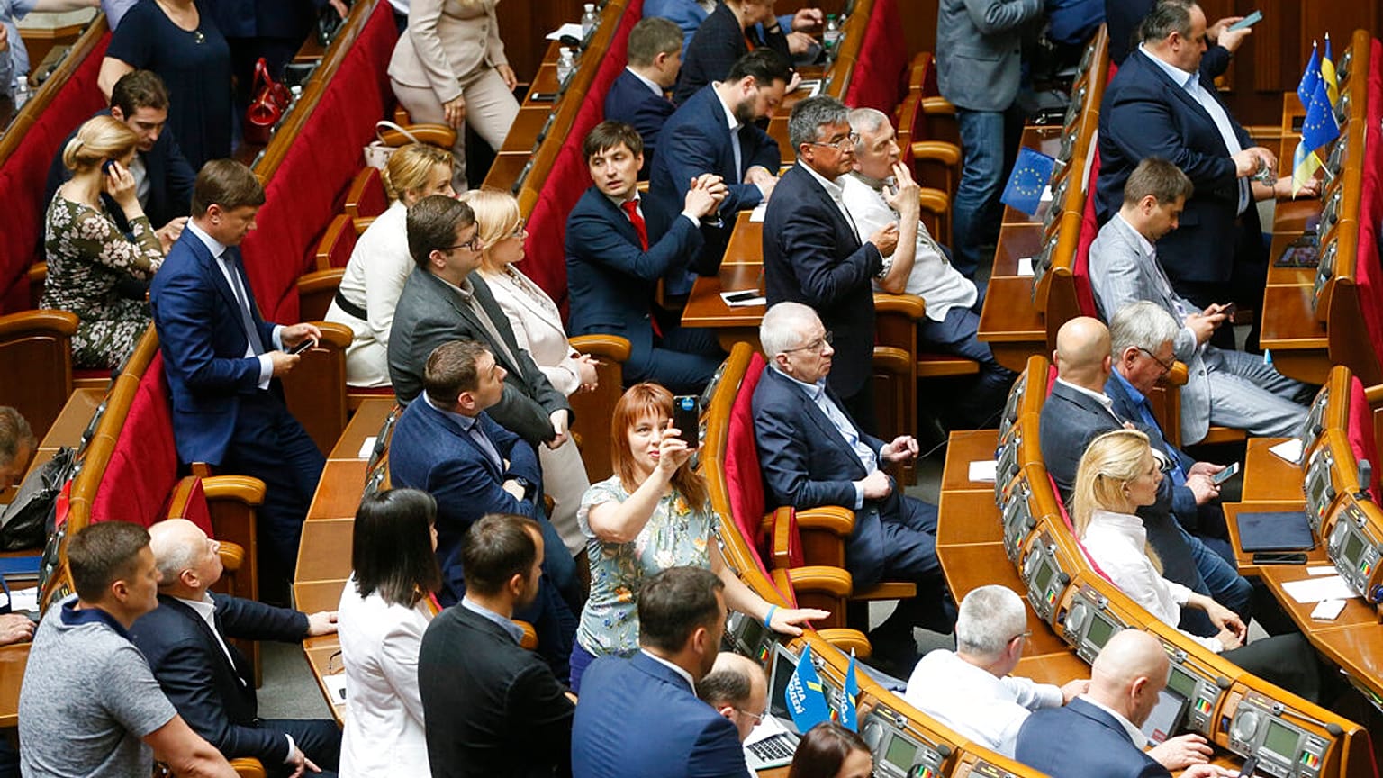 FILE - Ukraine's lawmakers react during a parliament session in Kiev, Ukraine, Wednesday, May 22, 2019.
