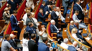 FILE - Ukraine's lawmakers react during a parliament session in Kiev, Ukraine, Wednesday, May 22, 2019.
