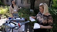 A woman prepares to cast her ballot during early voting in local elections in Donetsk, the capital of Russian-controlled Donetsk region, eastern Ukraine, on , Sept. 6th , 2023
