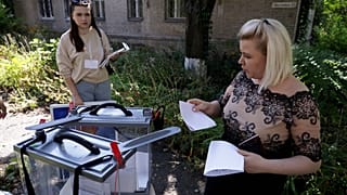 A woman prepares to cast her ballot during early voting in local elections in Donetsk, the capital of Russian-controlled Donetsk region, eastern Ukraine, on , Sept. 6th , 2023