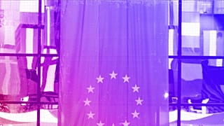 EU national flags are reflected in a window at the EU Council building in Brussels, June 2008