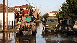 Residentes e elementos do exército grego cruzam a cidade inundada de Palamas, região central da Grécia, 8 de setembro 2023