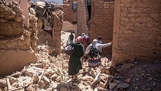 Residents flee their homes after an earthquake in Moulay Brahim village, near the epicentre of the earthquake, outside Marrakech, Morocco on Saturday