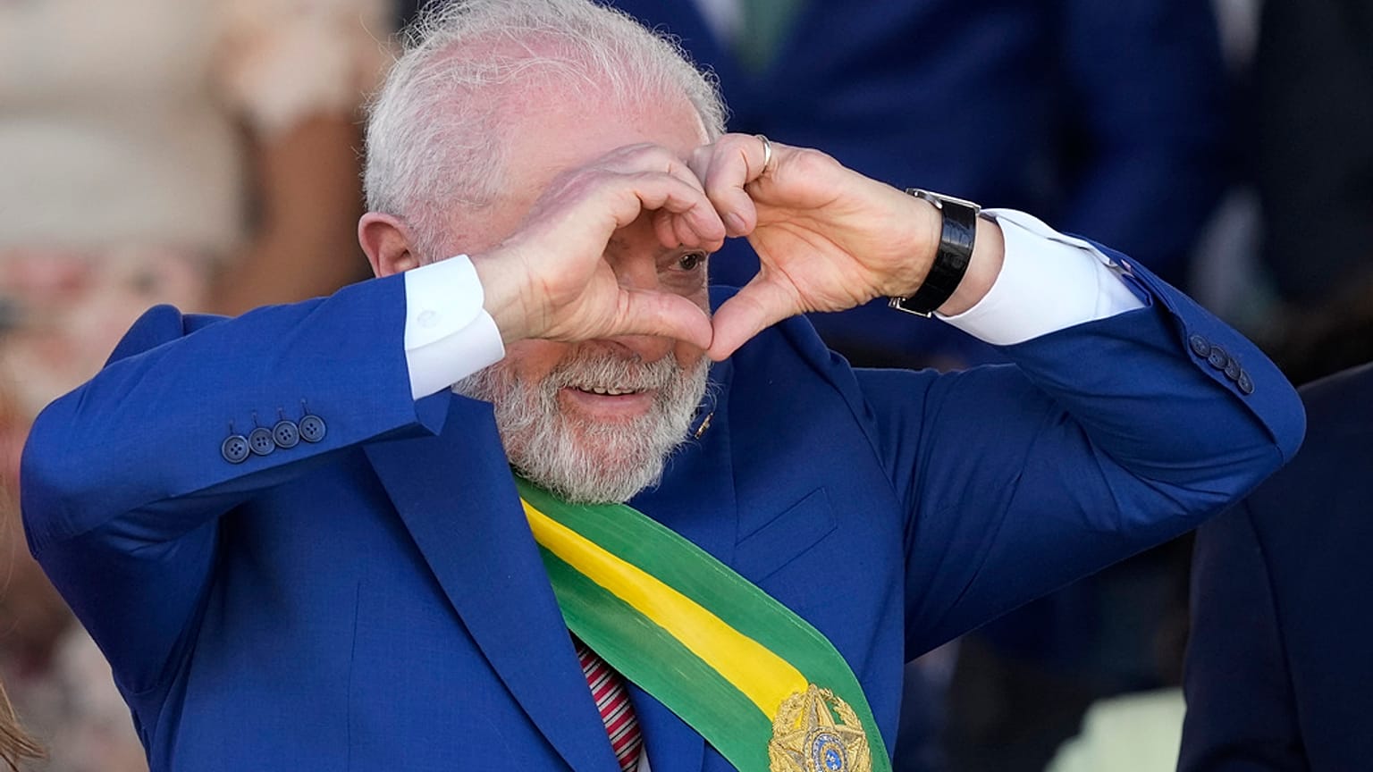 Brazilian President Luiz Inacio Lula da Silva makes a heart sign during a military parade on Independence Day in Brasilia, Brazil, Thursday, Sept. 7, 2023. 