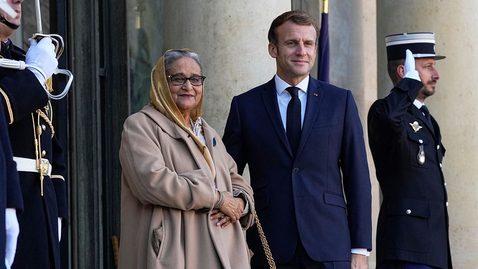 Prime Minister of Bangladesh Sheikh Hasina Wazed, left, is welcomed by French President Emmanuel Macron at the Elysee Palace in Paris, Tuesday, Nov. 9, 2021.