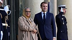 Prime Minister of Bangladesh Sheikh Hasina Wazed, left, is welcomed by French President Emmanuel Macron at the Elysee Palace in Paris, Tuesday, Nov. 9, 2021.