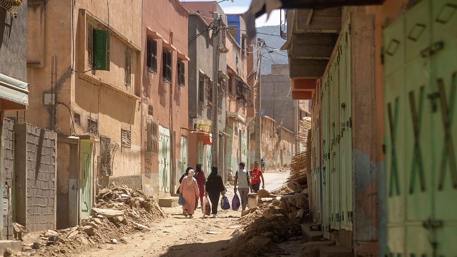 People carry some of their possessions as they leave their town which was damaged by the earthquake, in Amizmiz, near Marrakech, Morocco.