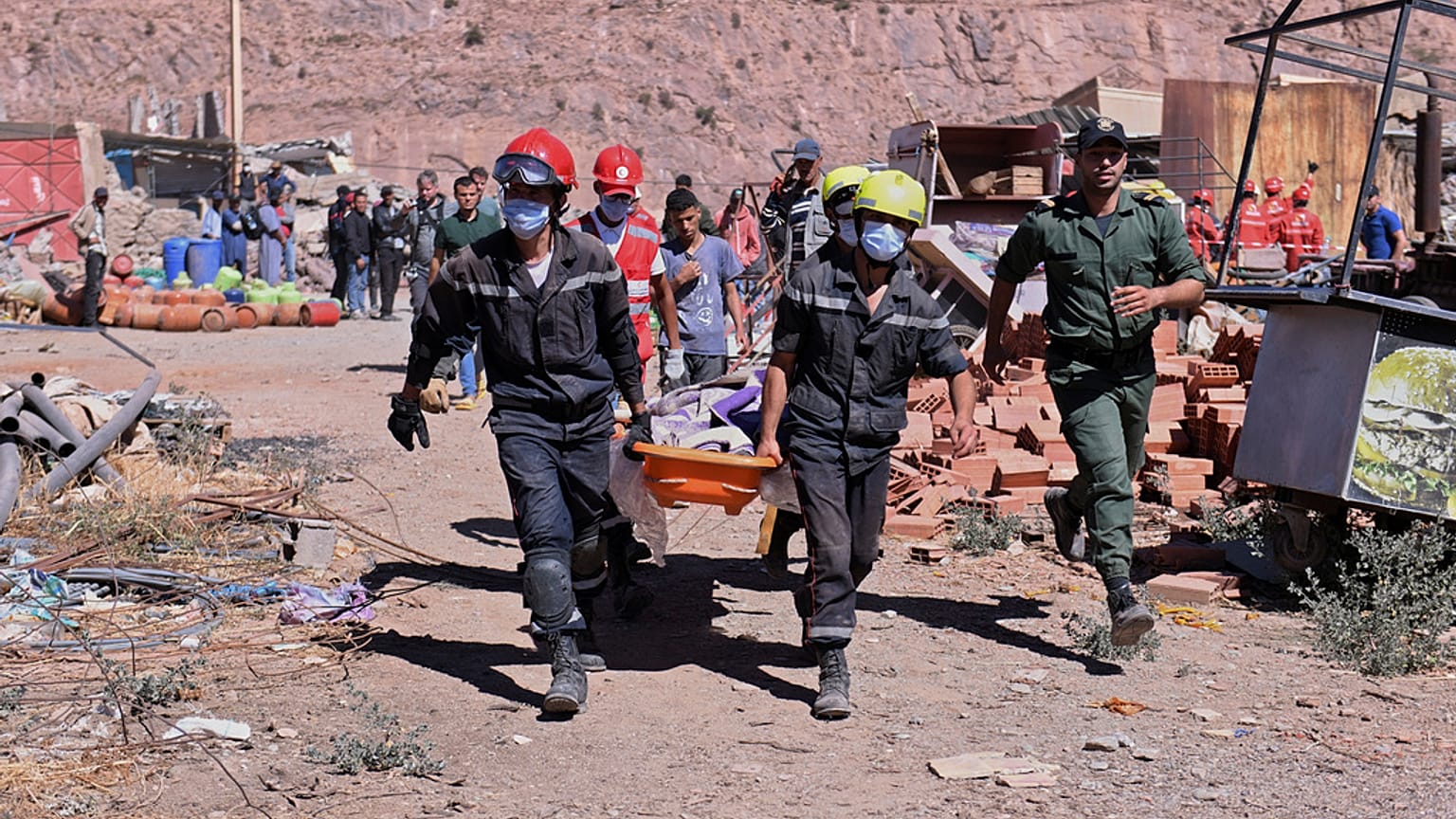 A victim is carried away by rescue workers in Talat N'yakoub, Morocco, Monday Sept. 11, 2023.