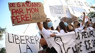 Women hold banners reading 'Unleash the words' and 'From 6 to 10 by my father' during an anti-abuse demonstration in Corsica.