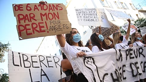 Women hold banners reading 'Unleash the words' and 'From 6 to 10 by my father' during an anti-abuse demonstration in Corsica.