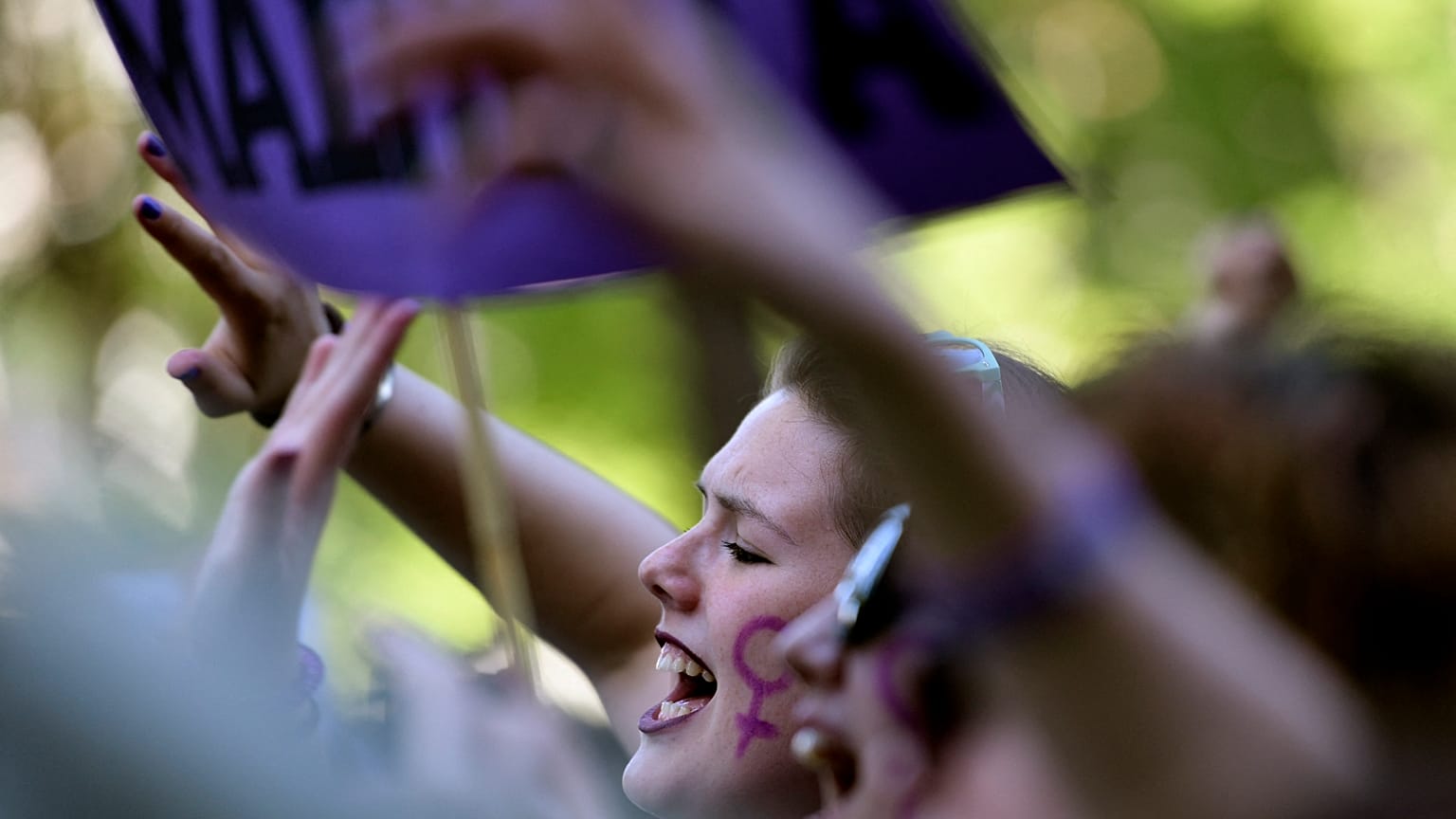 Demonstrators hold placards and shout slogans during a protest in Madrid AGAINST "La Manada"