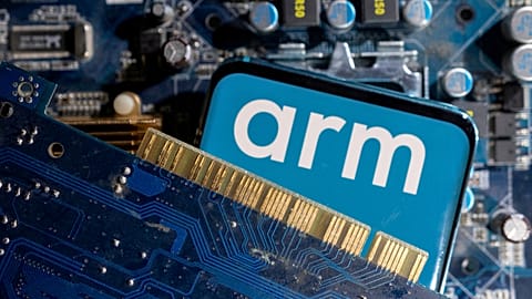 A smartphone with a displayed Arm Ltd logo is placed on a computer motherboard