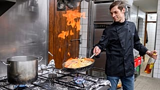 Vitaly from Kyiv helps in the kitchen with the Glas family in Dippertz, Germany, Tuesday, April 5, 2022.