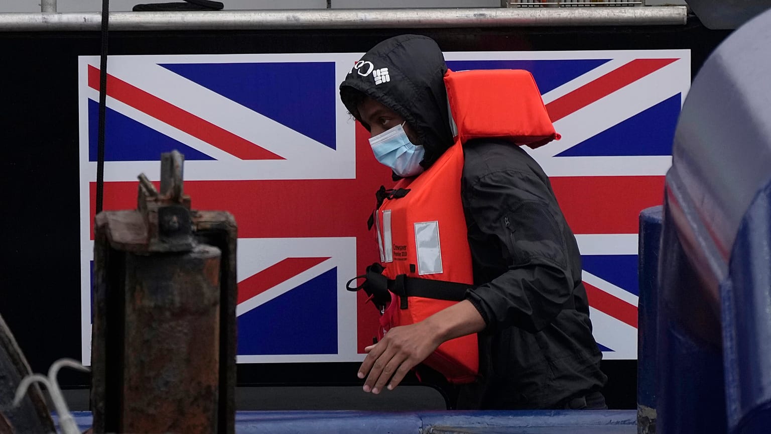 A man thought to be a migrant who made the crossing from France disembarks after being picked up in the English Channel by a British border force vessel.